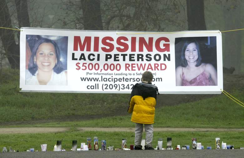 MODESTO, CA - JANUARY 4:  A young child stops to look at a makeshift memorial and a missing person's banner offering a half-million dollar reward for the safe return of Laci Peterson at the East La Loma Park January 4, 2003 in Modesto, California. Peterson, who is eight-months pregnant, has been missing since December 24, 2002 when she allegedly took her dog for a walk in the park while her husband was on a fishing trip.  (Photo by Justin Sullivan/Getty Images)