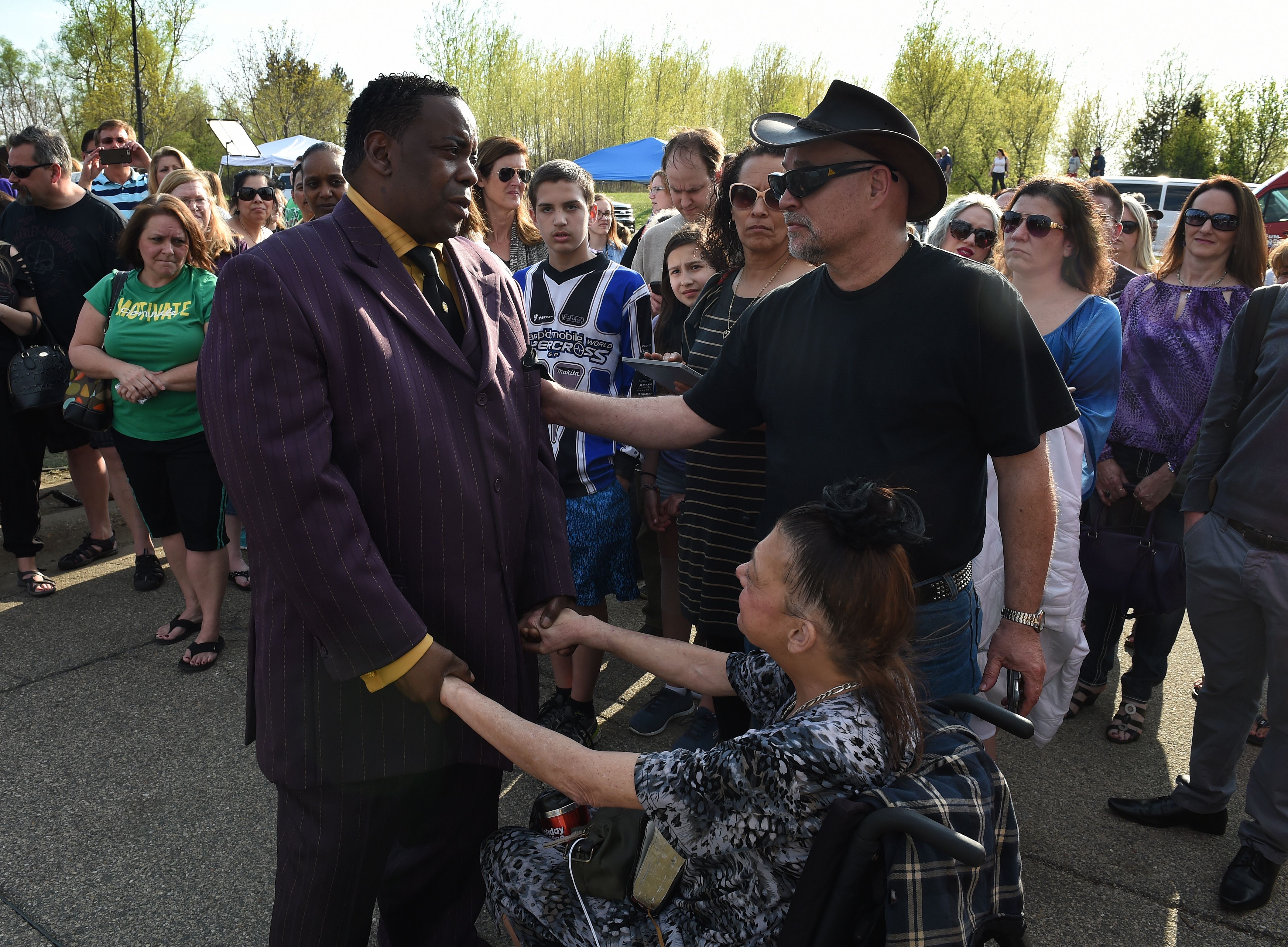 Maurice Phillips, left, the brother-in-law of Prince, talks with fans following a memorial service held inside the Paisley Park compound of music legend Prince. (Getty)