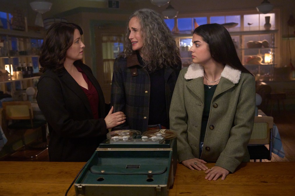 Alice, Kat and Del talk while standing in front of some type of tape machine