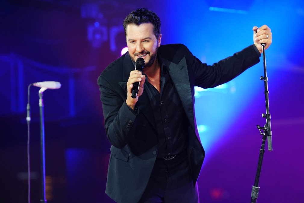 Luke Bryan singing into a microphone