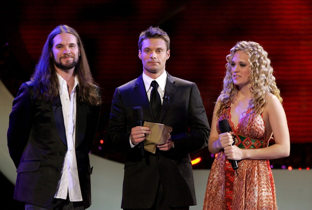 Carrie Underwood standing with Ryan Seacrest and Bo Bice