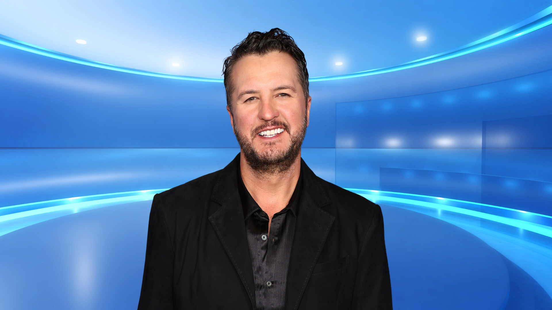 Luke Bryan smiling on a colorful stage