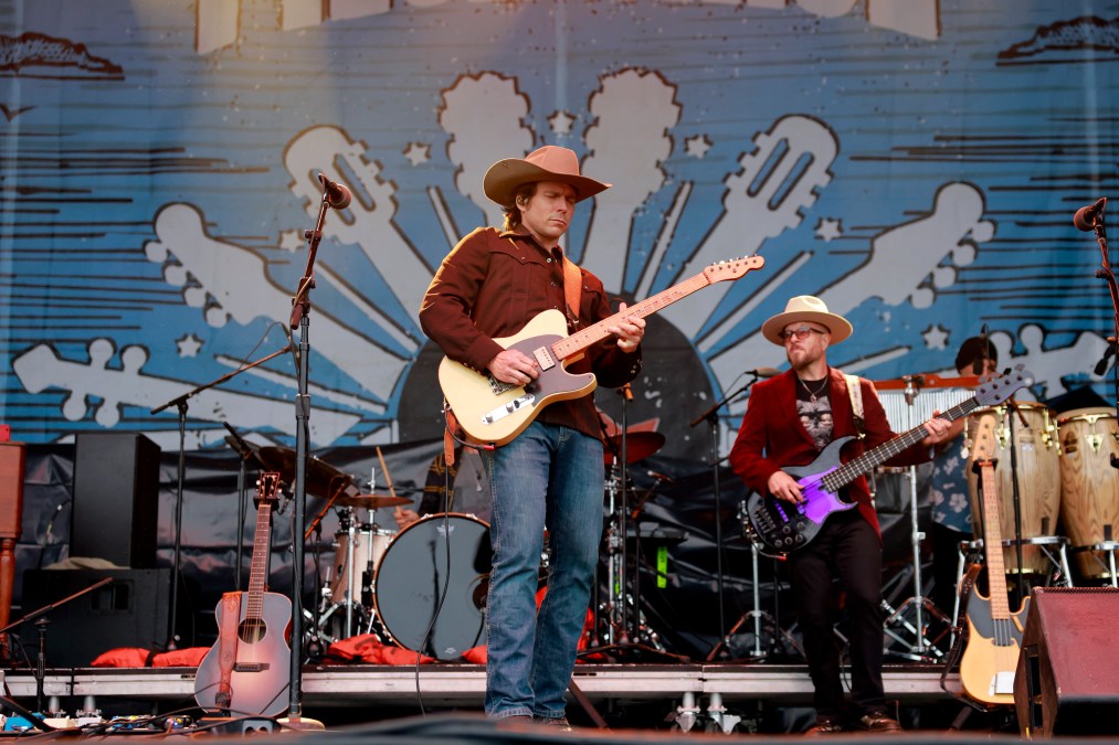 Lukas Nelson playing guitar on stage