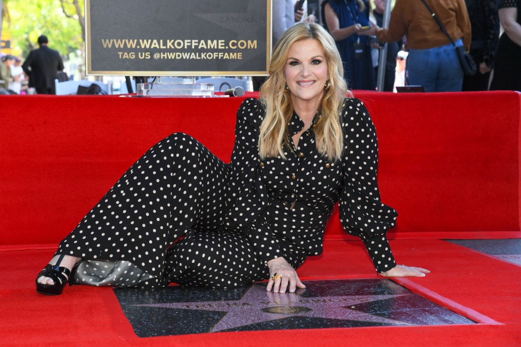 Trisha Year wood posing with her star on the Hollywood Walk of Fame