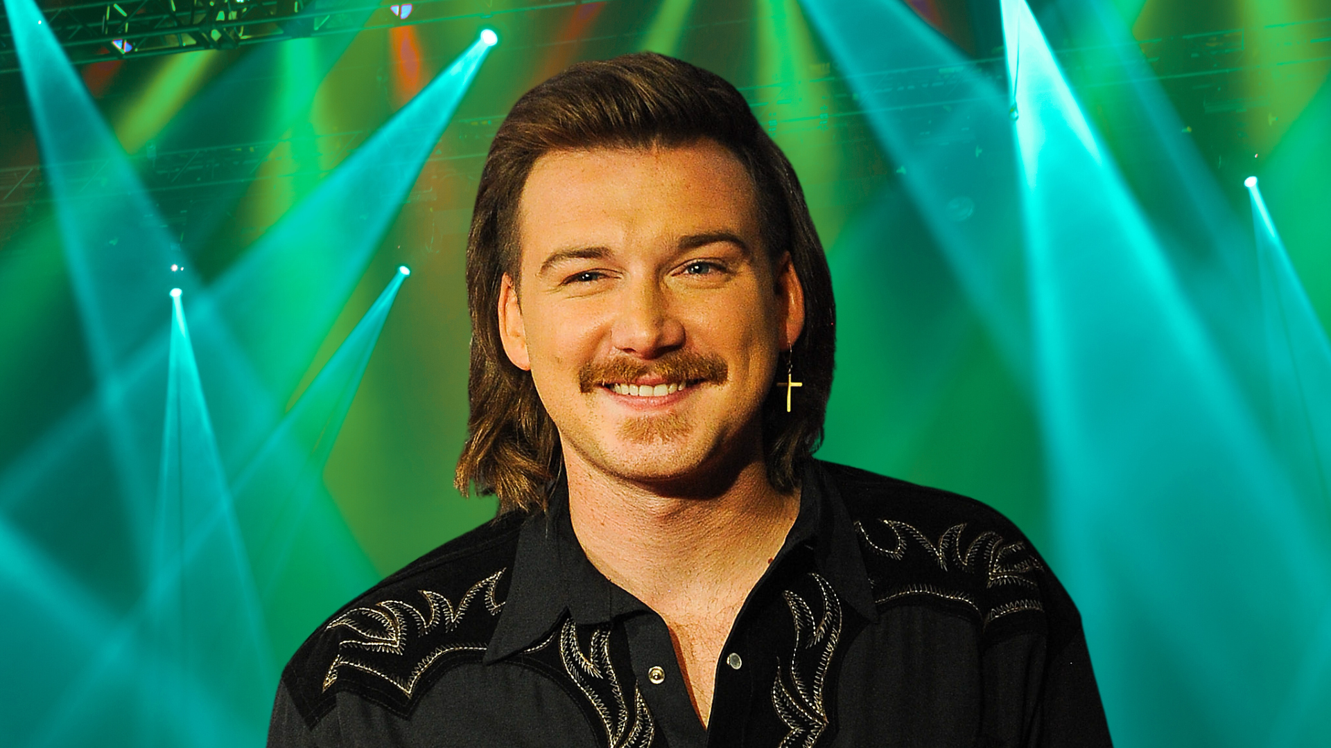 Morgan Wallen smiling with an earring