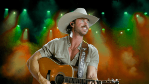 Riley Green playing guitar on stage.
