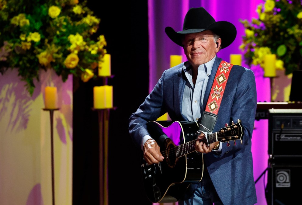 George Strait holding a guitar