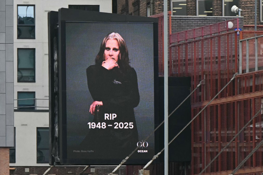 A photograph taken on July 23, 2025 shows an advertising board displaying a picture of late British singer-songwriter Ozzy Osbourne