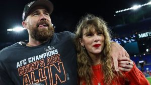 Travis Kelce #87 of the Kansas City Chiefs (L) celebrates with Taylor Swift after defeating the Baltimore Ravens in the AFC Championship Game