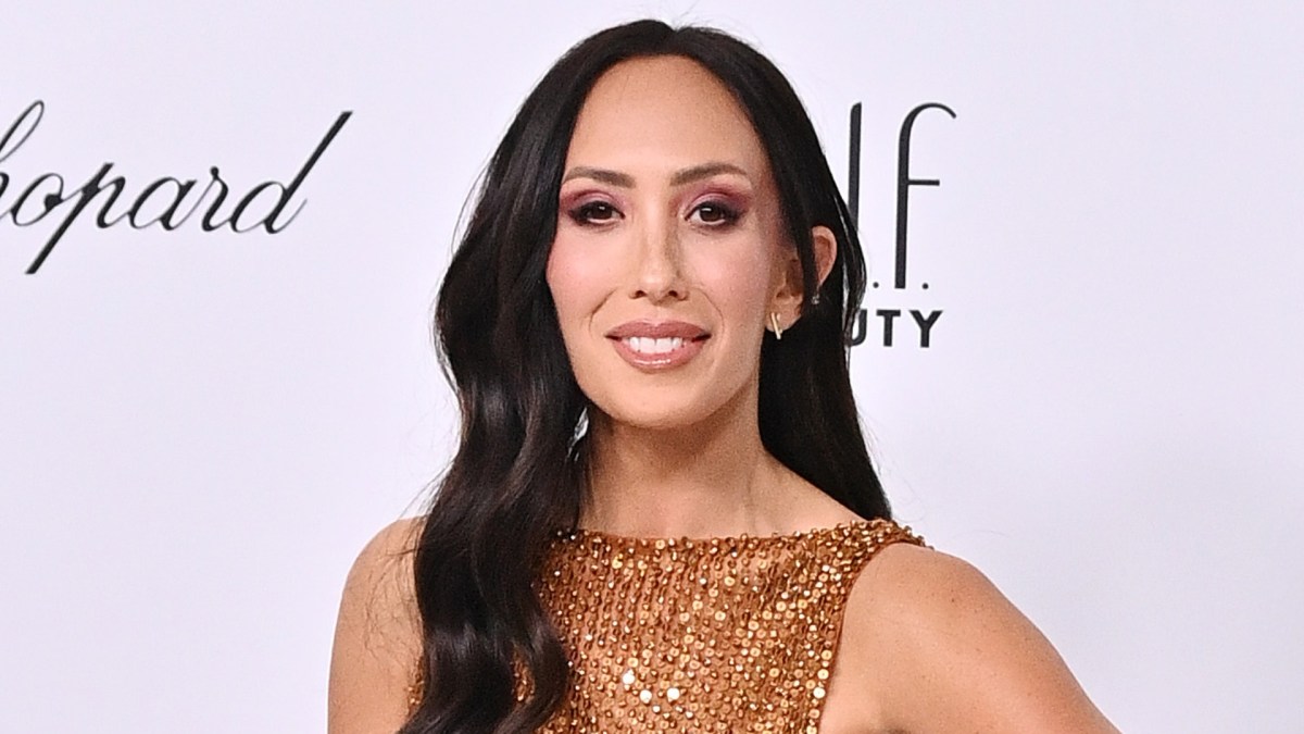 Cheryl Burke smiling at an event