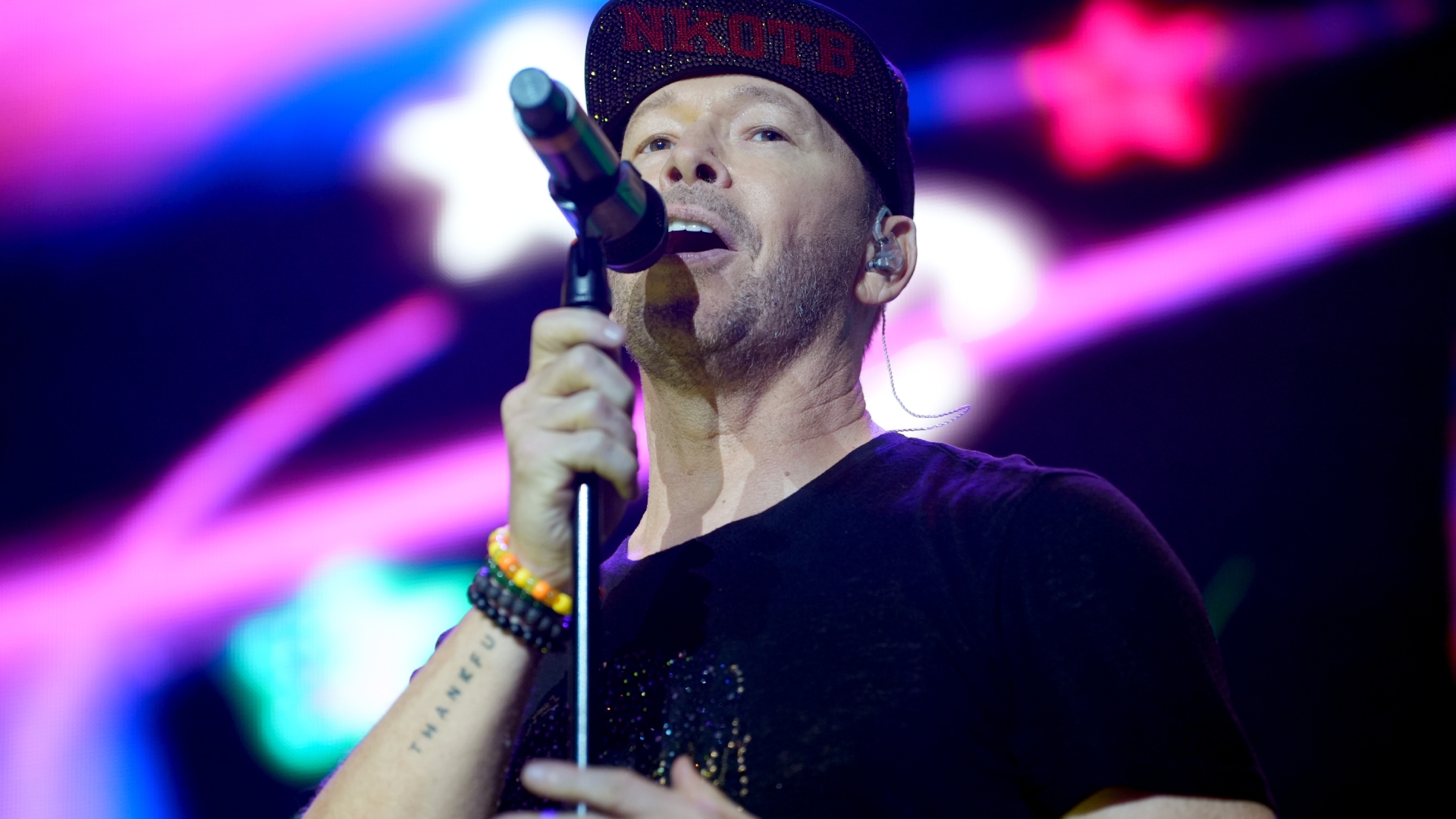 Donnie Wahlberg singing onstage with New Kids on the Block