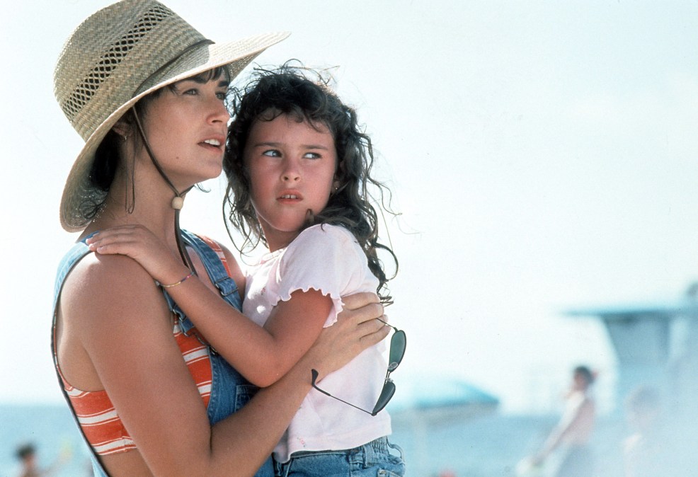 Demi Moore holds her daughter, Rumer Willis in a scene from the film 'Striptease', 1996. 