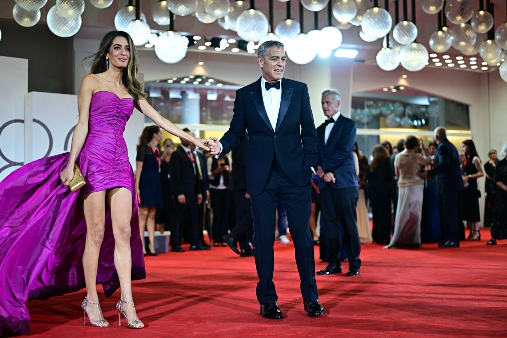 US actor George Clooney and his wife Amal Clooney walk the red carpet before the screening of the movie "Jay Kelly" presented in competition at the 82nd International Venice Film Festival, at Venice Lido on August 28, 2025. 