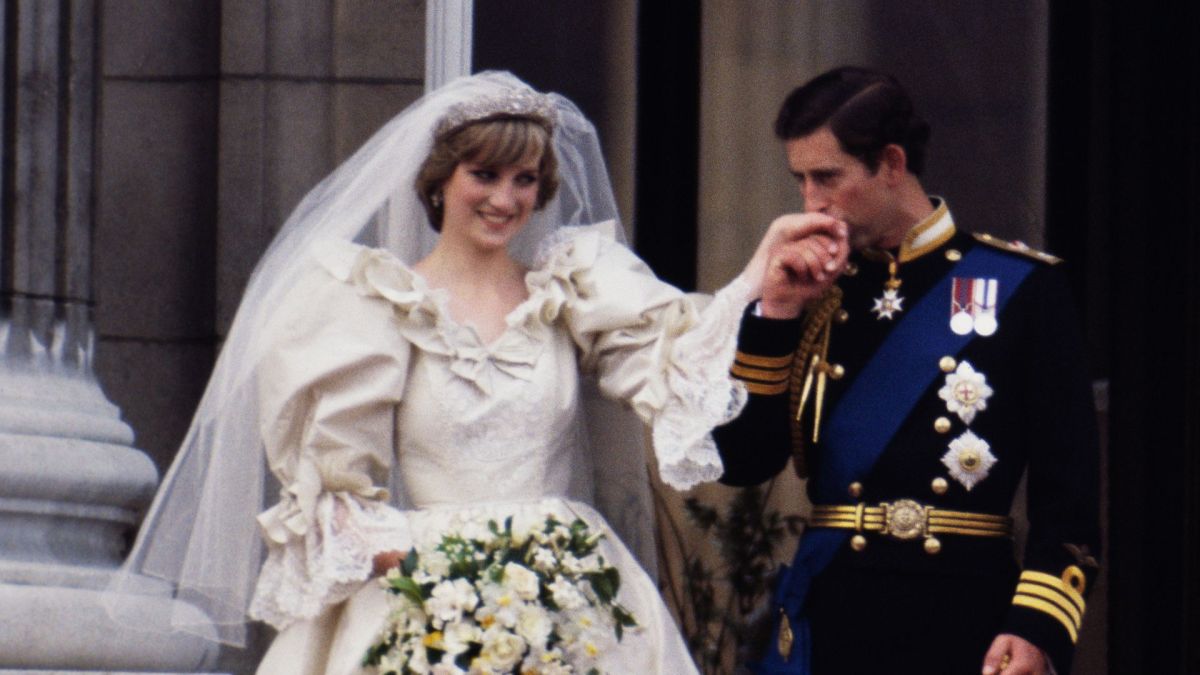 The Prince and Princess of Wales on the balcony of Buckingham Palace on their wedding day, 29th July 1981. Diana wears a wedding dress by David and Elizabeth Emmanuel and the Spencer family tiara