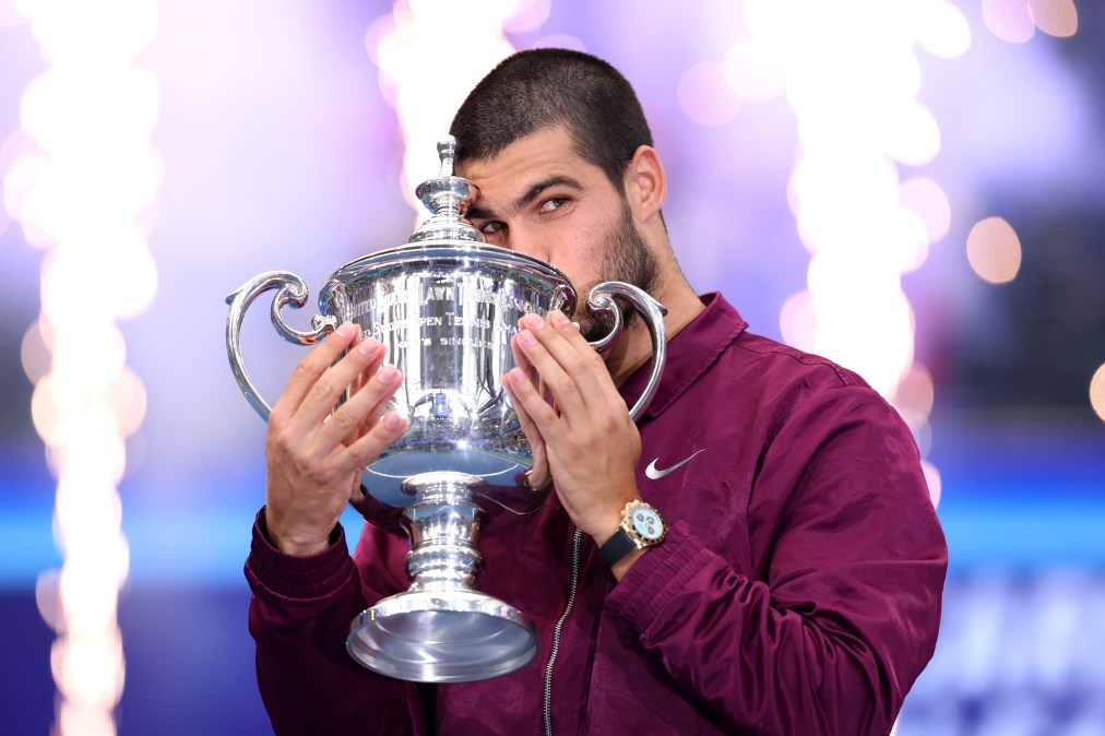 Carlos Alcaraz of Spain kisses the trophy