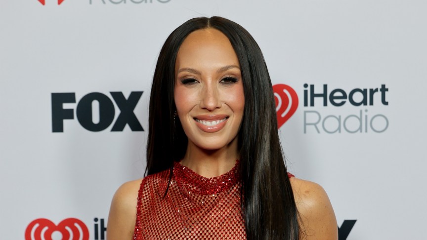 Cheryl Burke smiling for photos at an event