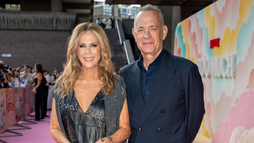 Rita Wilson and Tom Hanks smile and pose for photos
