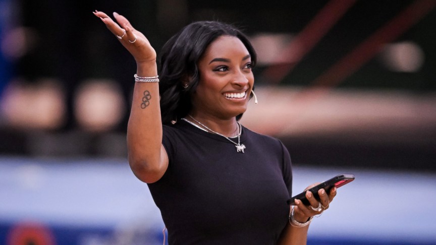 Simone Biles smiling and waving