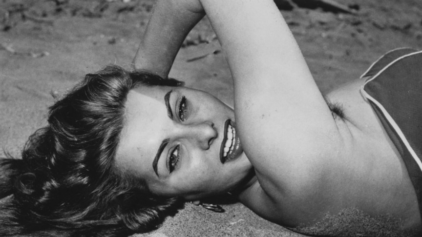 Sophia Loren on a beach, smiling