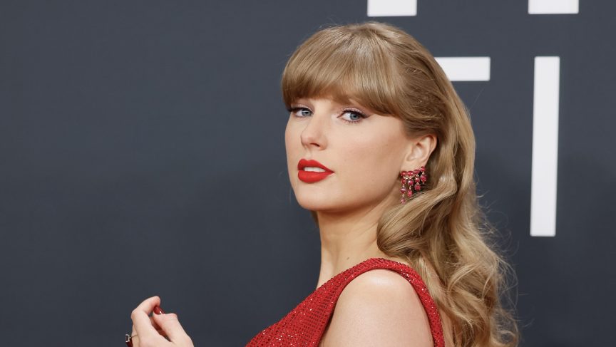 Taylor Swift poses in red dress